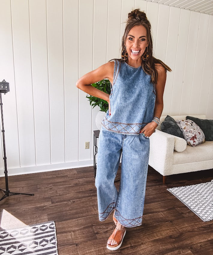 Light wash denim set that's equal parts effortless and eye-catching. The tank features a hook-and-eye neck closure and loose hem, while caramel embroidered stitching adds personality throughout. Pair it with the matching wide-leg pants—complete with button-zip closure, elastic back waist, front and side pleating, and pockets lined with the same playful embroidered detail.