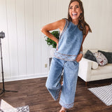 Light wash denim set that's equal parts effortless and eye-catching. The tank features a hook-and-eye neck closure and loose hem, while caramel embroidered stitching adds personality throughout. Pair it with the matching wide-leg pants—complete with button-zip closure, elastic back waist, front and side pleating, and pockets lined with the same playful embroidered detail.