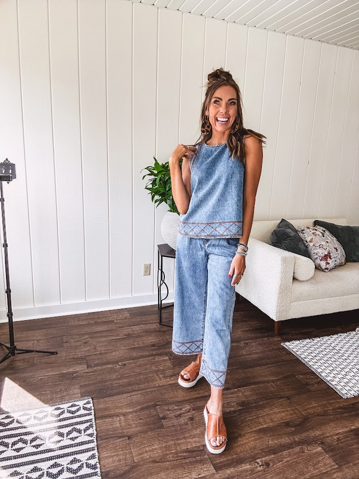 Light wash denim set that's equal parts effortless and eye-catching. The tank features a hook-and-eye neck closure and loose hem, while caramel embroidered stitching adds personality throughout. Pair it with the matching wide-leg pants—complete with button-zip closure, elastic back waist, front and side pleating, and pockets lined with the same playful embroidered detail.
