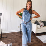 Light wash denim set that's equal parts effortless and eye-catching. The tank features a hook-and-eye neck closure and loose hem, while caramel embroidered stitching adds personality throughout. Pair it with the matching wide-leg pants—complete with button-zip closure, elastic back waist, front and side pleating, and pockets lined with the same playful embroidered detail.