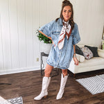 Denim Diva energy meets versatile style. This batwing beauty shifts from jacket to shirt to dress—layer it over everything or let it stand solo. Medium wash, metal button details, and flattering seam work make it endlessly cool. 