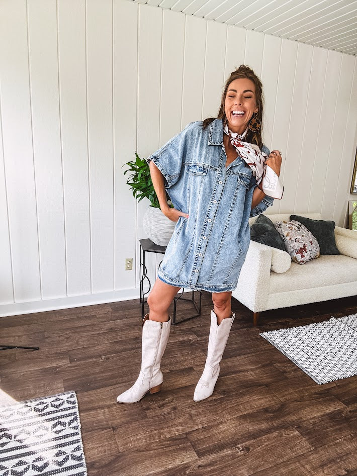 Denim Diva energy meets versatile style. This batwing beauty shifts from jacket to shirt to dress—layer it over everything or let it stand solo. Medium wash, metal button details, and flattering seam work make it endlessly cool. 