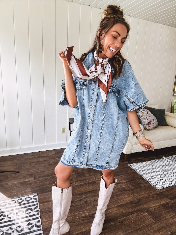Denim Diva energy meets versatile style. This batwing beauty shifts from jacket to shirt to dress—layer it over everything or let it stand solo. Medium wash, metal button details, and flattering seam work make it endlessly cool. 