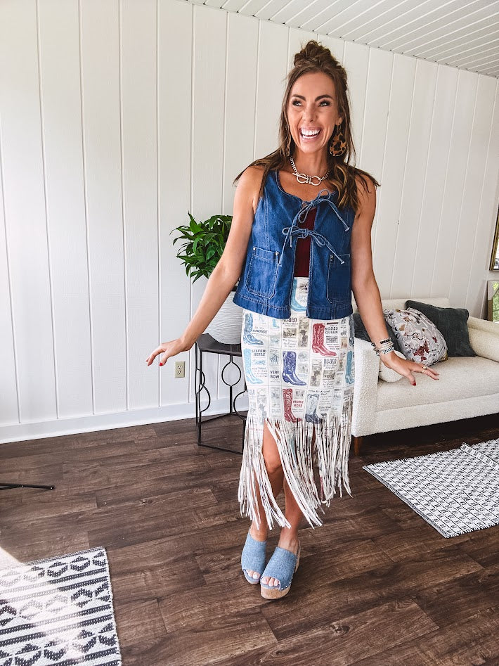 Medium wash denim vest is your new go-to layer. The open front with playful tie closures and contrast-stitched pockets.