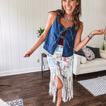 Medium wash denim vest is your new go-to layer. The open front with playful tie closures and contrast-stitched pockets.