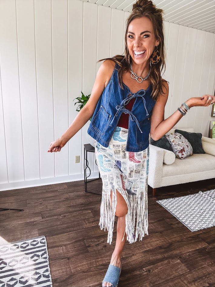 Medium wash denim vest is your new go-to layer. The open front with playful tie closures and contrast-stitched pockets.