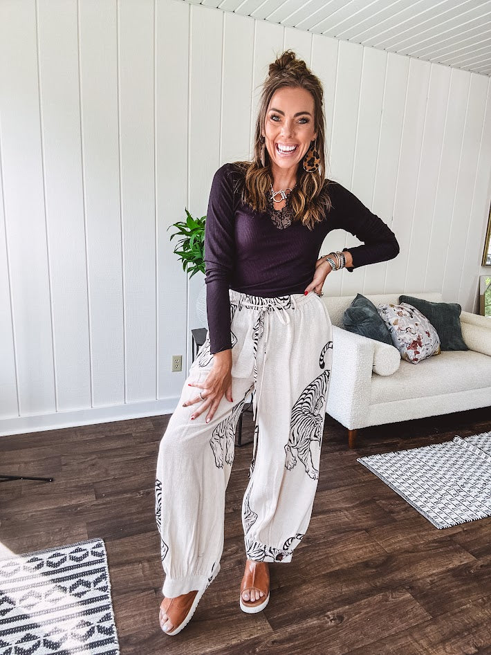 This black baby rib top is your new closet essential. The delicate lace inset at the V neckline adds just enough intrigue, while the ribbed texture and generous stretch make it impossibly comfortable.