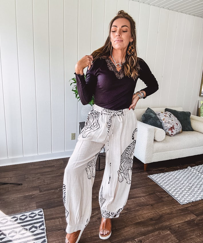 This black baby rib top is your new closet essential. The delicate lace inset at the V neckline adds just enough intrigue, while the ribbed texture and generous stretch make it impossibly comfortable.