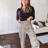  The MIX MATCH LEOPARD STRIPE PANT blends bold brown and cream stripes on one leg with fierce leopard print on the other—all in a soft, denim-like fabric that feels as good as it looks. The elastic back waist keeps you comfy while the button and zipper front keeps things polished. 