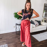 These vintage-inspired wide leg pants are a total vibe—low-rise silhouette with playful silver eyelets and studs running down the sides that catch the light just right. Crafted from lightweight 100% cotton denim with that perfect worn-in wash. The button and zipper closure with elastic back waist keeps them comfortable all day long. Ultra-wide legs that make a statement.