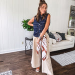 These vintage-inspired wide leg pants are a total vibe—low-rise silhouette with playful silver eyelets and studs running down the sides that catch the light just right. Crafted from lightweight 100% cotton denim with that perfect worn-in wash. The button and zipper closure with elastic back waist keeps them comfortable all day long. Ultra-wide legs that make a statement.