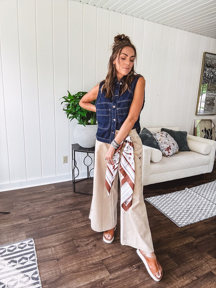 These vintage-inspired wide leg pants are a total vibe—low-rise silhouette with playful silver eyelets and studs running down the sides that catch the light just right. Crafted from lightweight 100% cotton denim with that perfect worn-in wash. The button and zipper closure with elastic back waist keeps them comfortable all day long. Ultra-wide legs that make a statement.
