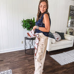 These vintage-inspired wide leg pants are a total vibe—low-rise silhouette with playful silver eyelets and studs running down the sides that catch the light just right. Crafted from lightweight 100% cotton denim with that perfect worn-in wash. The button and zipper closure with elastic back waist keeps them comfortable all day long. Ultra-wide legs that make a statement.