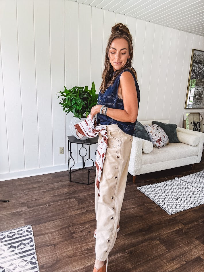 These vintage-inspired wide leg pants are a total vibe—low-rise silhouette with playful silver eyelets and studs running down the sides that catch the light just right. Crafted from lightweight 100% cotton denim with that perfect worn-in wash. The button and zipper closure with elastic back waist keeps them comfortable all day long. Ultra-wide legs that make a statement.