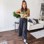 These vintage-inspired wide leg pants are a total vibe—low-rise silhouette with playful silver eyelets and studs running down the sides that catch the light just right. Crafted from lightweight 100% cotton denim with that perfect worn-in wash. The button and zipper closure with elastic back waist keeps them comfortable all day long. Ultra-wide legs that make a statement.