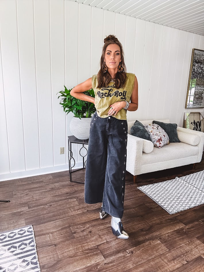 These vintage-inspired wide leg pants are a total vibe—low-rise silhouette with playful silver eyelets and studs running down the sides that catch the light just right. Crafted from lightweight 100% cotton denim with that perfect worn-in wash. The button and zipper closure with elastic back waist keeps them comfortable all day long. Ultra-wide legs that make a statement.