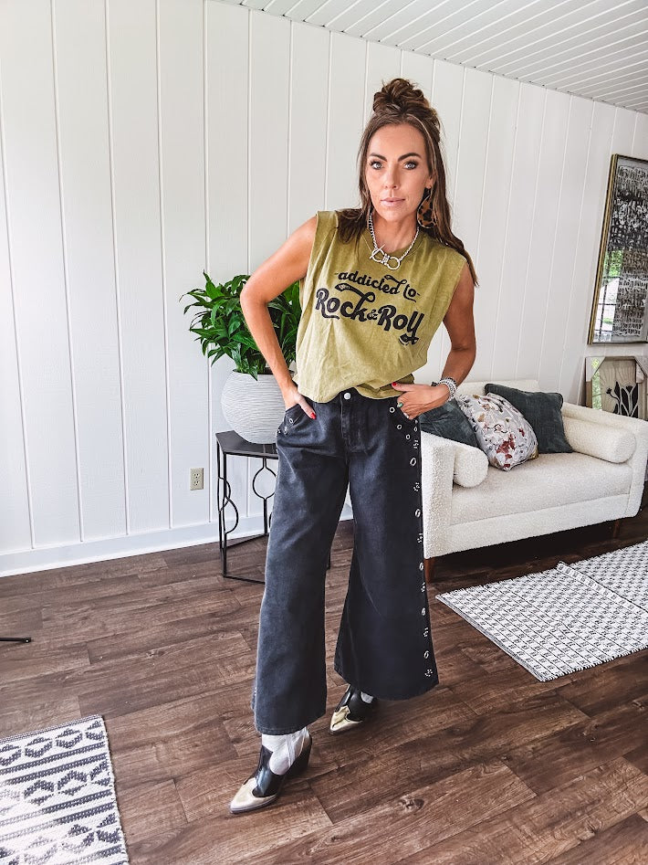 These vintage-inspired wide leg pants are a total vibe—low-rise silhouette with playful silver eyelets and studs running down the sides that catch the light just right. Crafted from lightweight 100% cotton denim with that perfect worn-in wash. The button and zipper closure with elastic back waist keeps them comfortable all day long. Ultra-wide legs that make a statement.