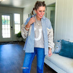 Nearly sheer open weave taupe woven sweater vest with fleece ivory horseshoe applique on the front, round neck, relaxed fit.