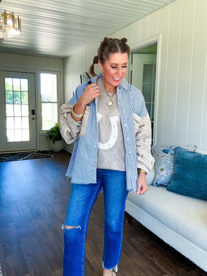 Nearly sheer open weave taupe woven sweater vest with fleece ivory horseshoe applique on the front, round neck, relaxed fit.