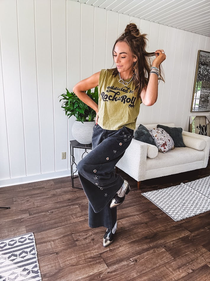 These vintage-inspired wide leg pants are a total vibe—low-rise silhouette with playful silver eyelets and studs running down the sides that catch the light just right. Crafted from lightweight 100% cotton denim with that perfect worn-in wash. The button and zipper closure with elastic back waist keeps them comfortable all day long. Ultra-wide legs that make a statement.