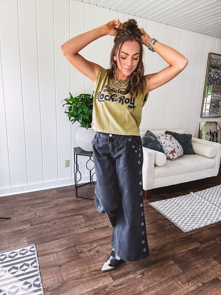 These vintage-inspired wide leg pants are a total vibe—low-rise silhouette with playful silver eyelets and studs running down the sides that catch the light just right. Crafted from lightweight 100% cotton denim with that perfect worn-in wash. The button and zipper closure with elastic back waist keeps them comfortable all day long. Ultra-wide legs that make a statement.