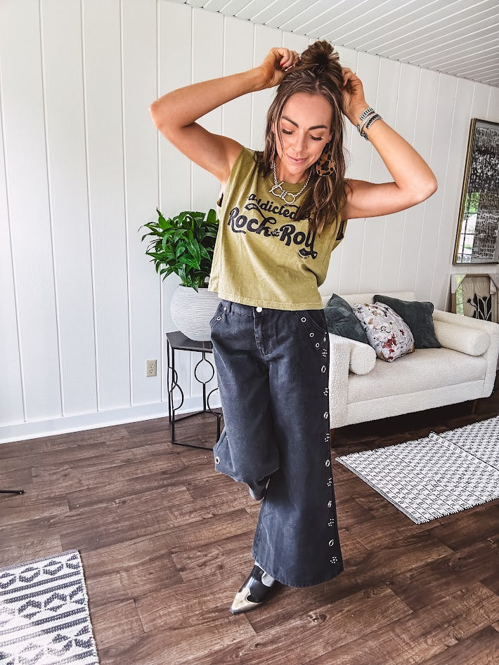 These vintage-inspired wide leg pants are a total vibe—low-rise silhouette with playful silver eyelets and studs running down the sides that catch the light just right. Crafted from lightweight 100% cotton denim with that perfect worn-in wash. The button and zipper closure with elastic back waist keeps them comfortable all day long. Ultra-wide legs that make a statement.