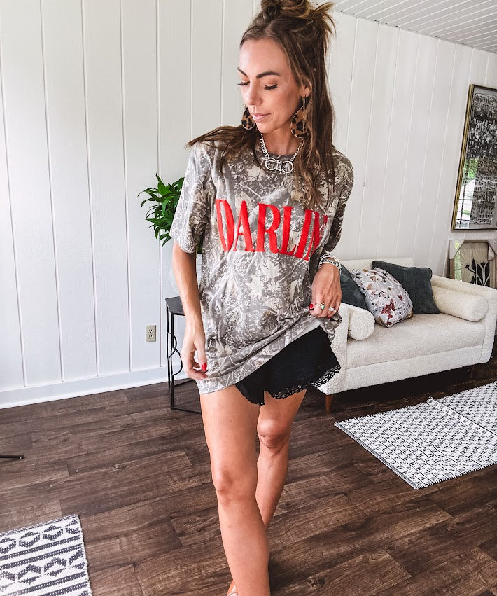 Light camo cotton tee with a bold, contrasting red "DARLIN'" graphic