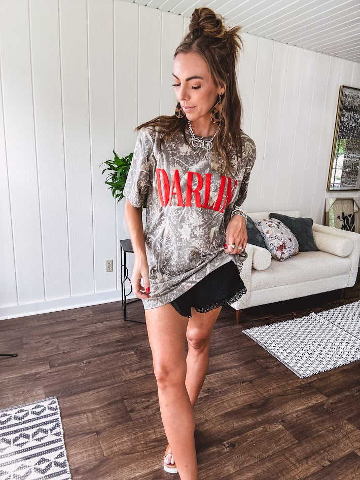 Light camo cotton tee with a bold, contrasting red "DARLIN'" graphic