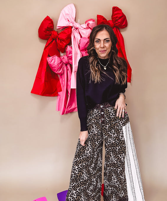 Cotton wide leg pants in a dark chocolate, white and black leo print with a white and black wide stripe panel down the side with button fly.
