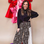Cotton wide leg pants in a dark chocolate, white and black leo print with a white and black wide stripe panel down the side with button fly.