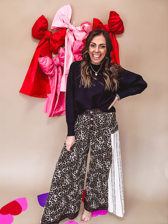 Cotton wide leg pants in a dark chocolate, white and black leo print with a white and black wide stripe panel down the side with button fly.