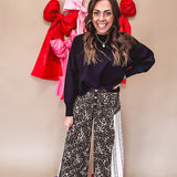 Cotton wide leg pants in a dark chocolate, white and black leo print with a white and black wide stripe panel down the side with button fly.