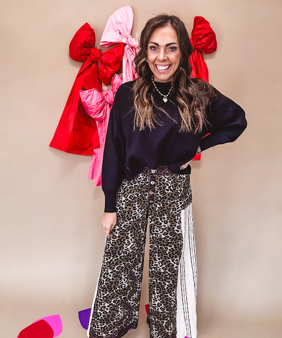 Cotton wide leg pants in a dark chocolate, white and black leo print with a white and black wide stripe panel down the side with button fly.