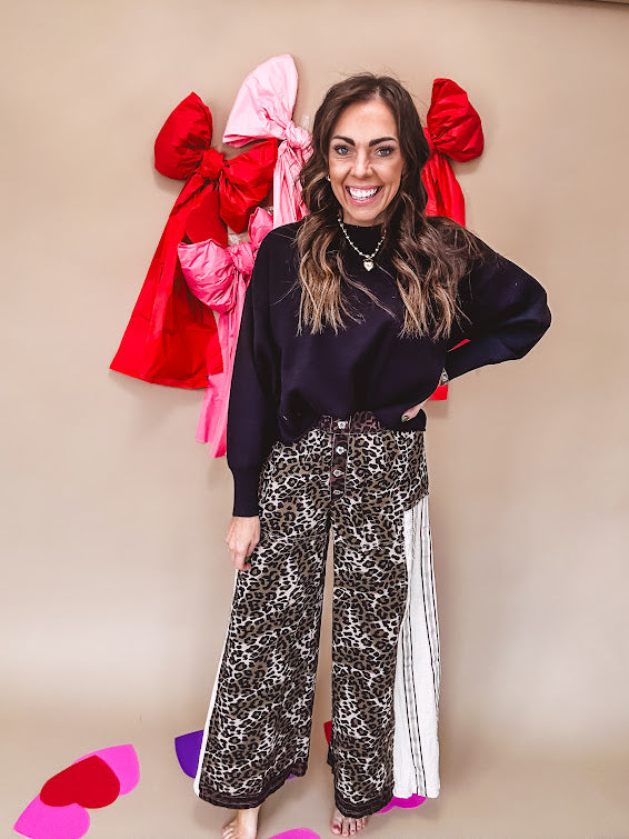 Cotton wide leg pants in a dark chocolate, white and black leo print with a white and black wide stripe panel down the side with button fly.