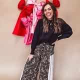 Cotton wide leg pants in a dark chocolate, white and black leo print with a white and black wide stripe panel down the side with button fly.
