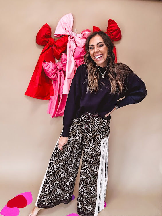 Cotton wide leg pants in a dark chocolate, white and black leo print with a white and black wide stripe panel down the side with button fly.