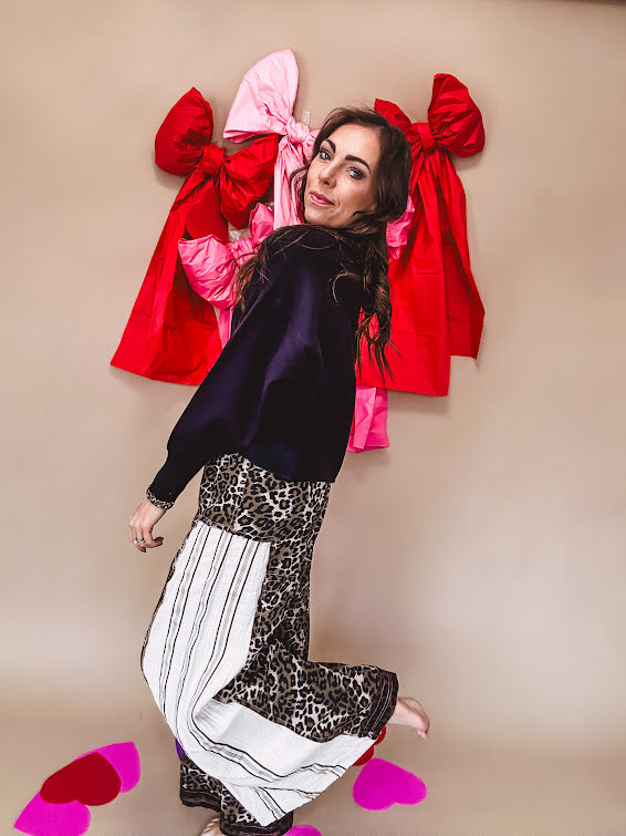 Cotton wide leg pants in a dark chocolate, white and black leo print with a white and black wide stripe panel down the side with button fly.