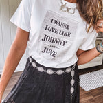 Crisp white cotton tee with a shorter hemline and bold newsprint graphic celebrating iconic love—"I Wanna Love Like Johnny and June."