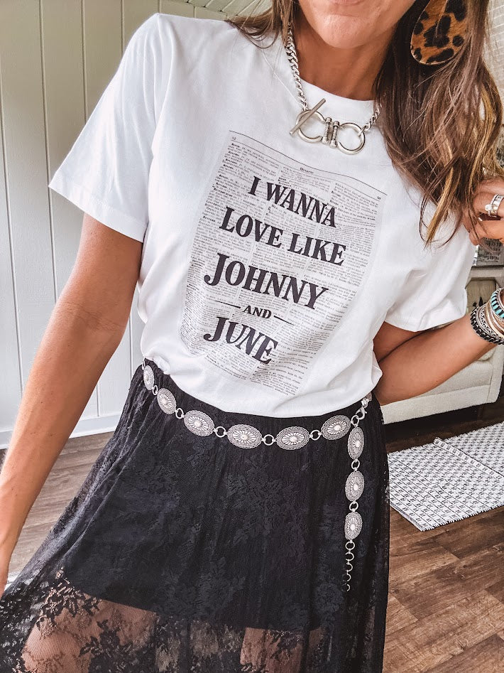 Crisp white cotton tee with a shorter hemline and bold newsprint graphic celebrating iconic love—"I Wanna Love Like Johnny and June."