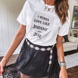 Crisp white cotton tee with a shorter hemline and bold newsprint graphic celebrating iconic love—"I Wanna Love Like Johnny and June."