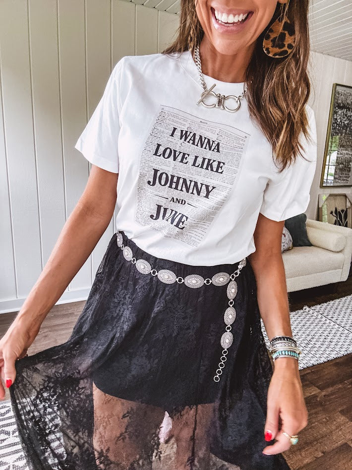 Crisp white cotton tee with a shorter hemline and bold newsprint graphic celebrating iconic love—"I Wanna Love Like Johnny and June."