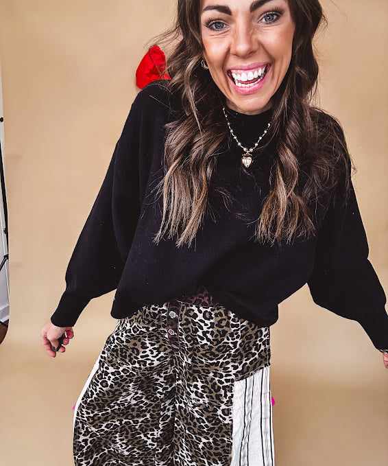 Round neck, crew style cropped sweater with drop shoulder available in black, white and wine.