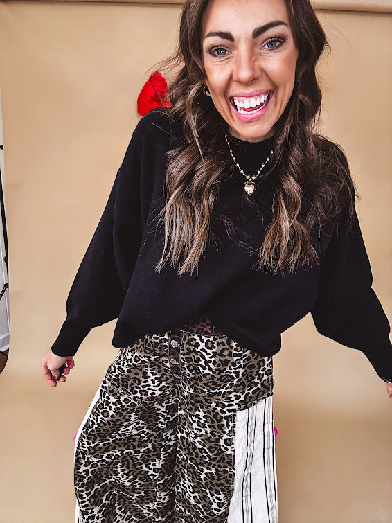Round neck, crew style cropped sweater with drop shoulder available in black, white and wine.