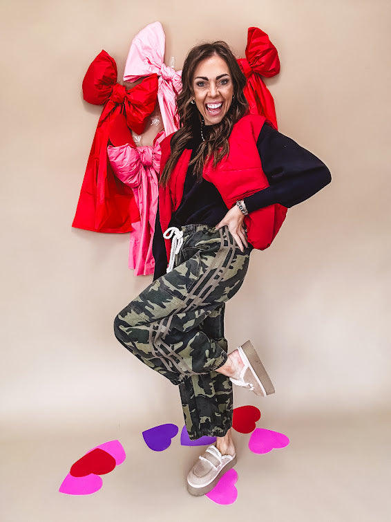 Vibrant true red puffer vest with zipper front and pockets.