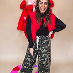 Vibrant true red puffer vest with zipper front and pockets.