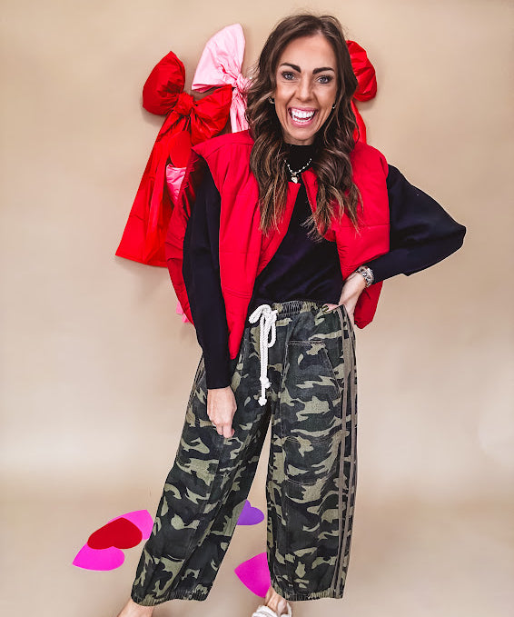 Vibrant true red puffer vest with zipper front and pockets.
