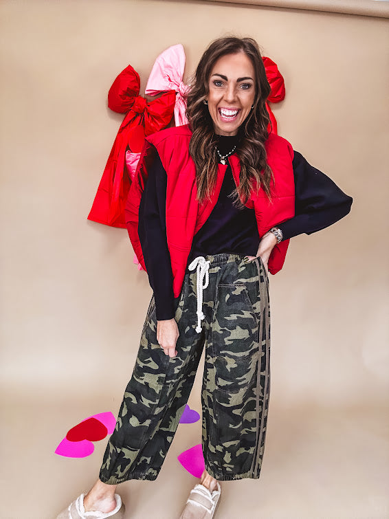 Vibrant true red puffer vest with zipper front and pockets.