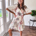 Cream V-neck mini dress with red, taupe, and leopard hearts and stars, lace overlay, ruffled puff sleeves, and an elastic hem. The stretchy, flowy silhouette flatters and flows.