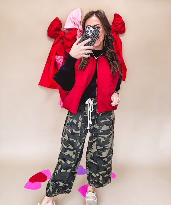 Vibrant true red puffer vest with zipper front and pockets.