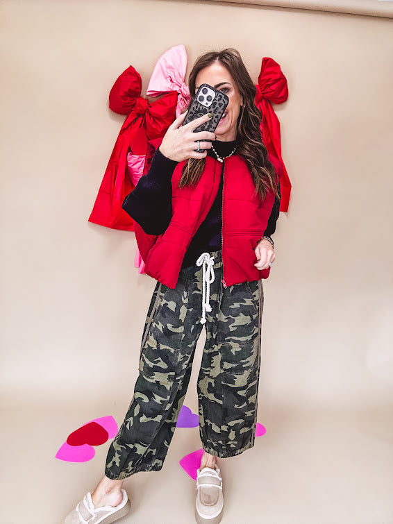 Vibrant true red puffer vest with zipper front and pockets.